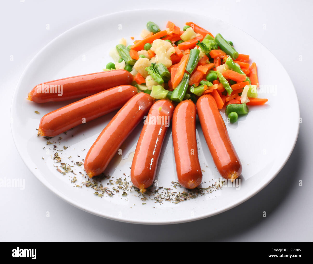 Sausages with boiled vegetables Stock Photo