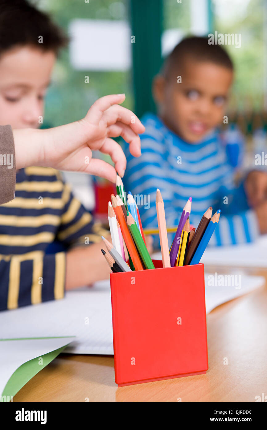 Child choosing coloured pencil Stock Photo - Alamy