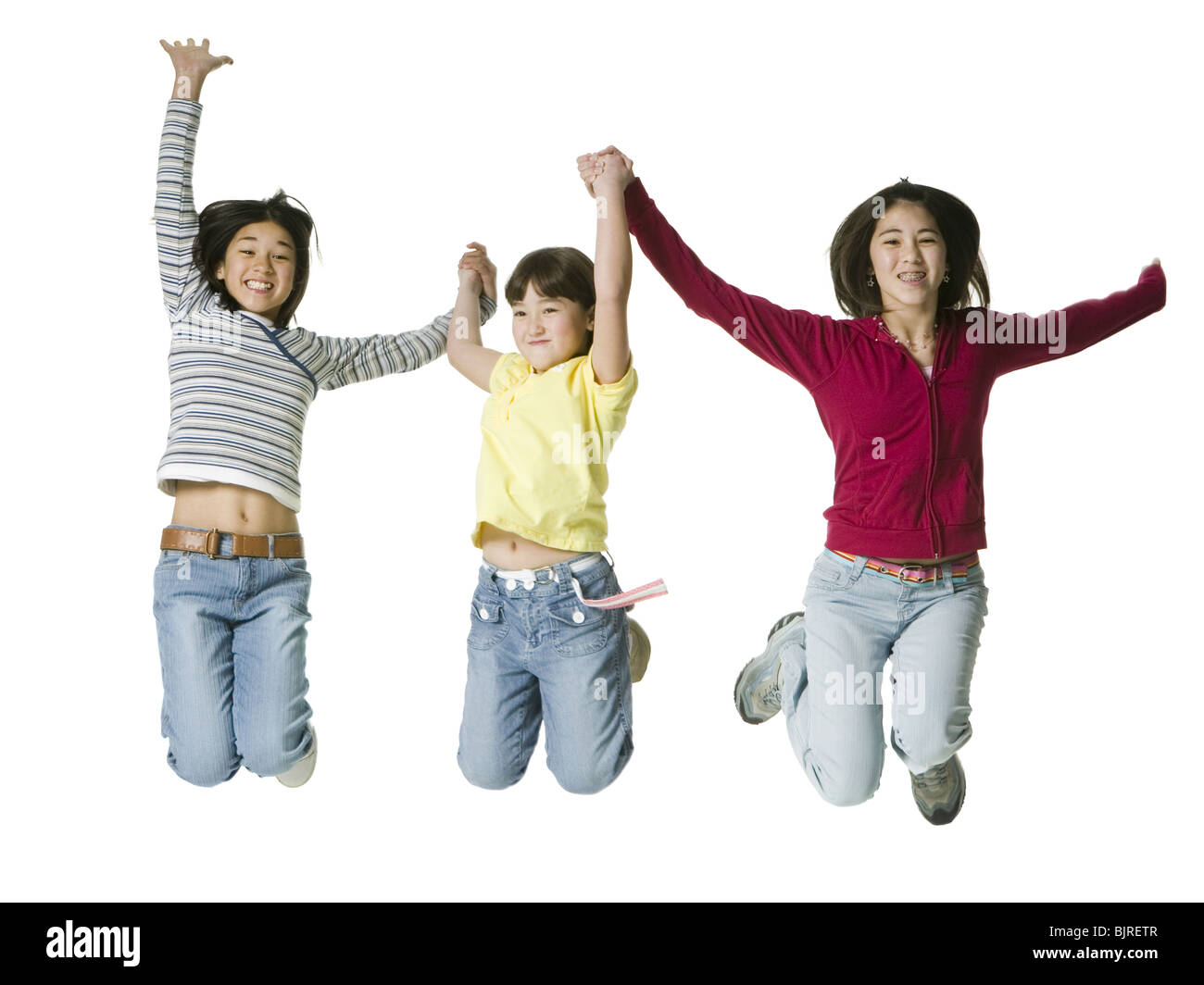 Three children leaping in the air Stock Photo