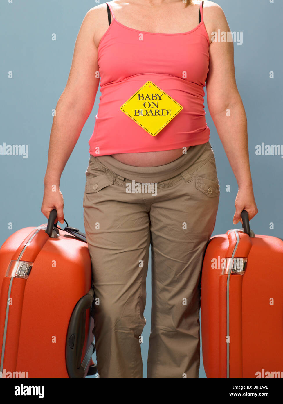 Pregnant woman carrying suitcases Stock Photo Alamy
