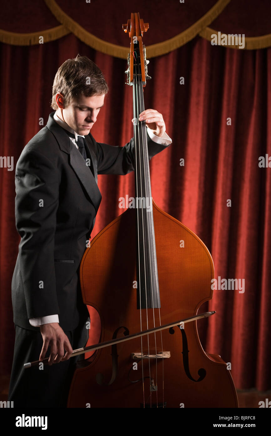 Young man playing double bass Stock Photo