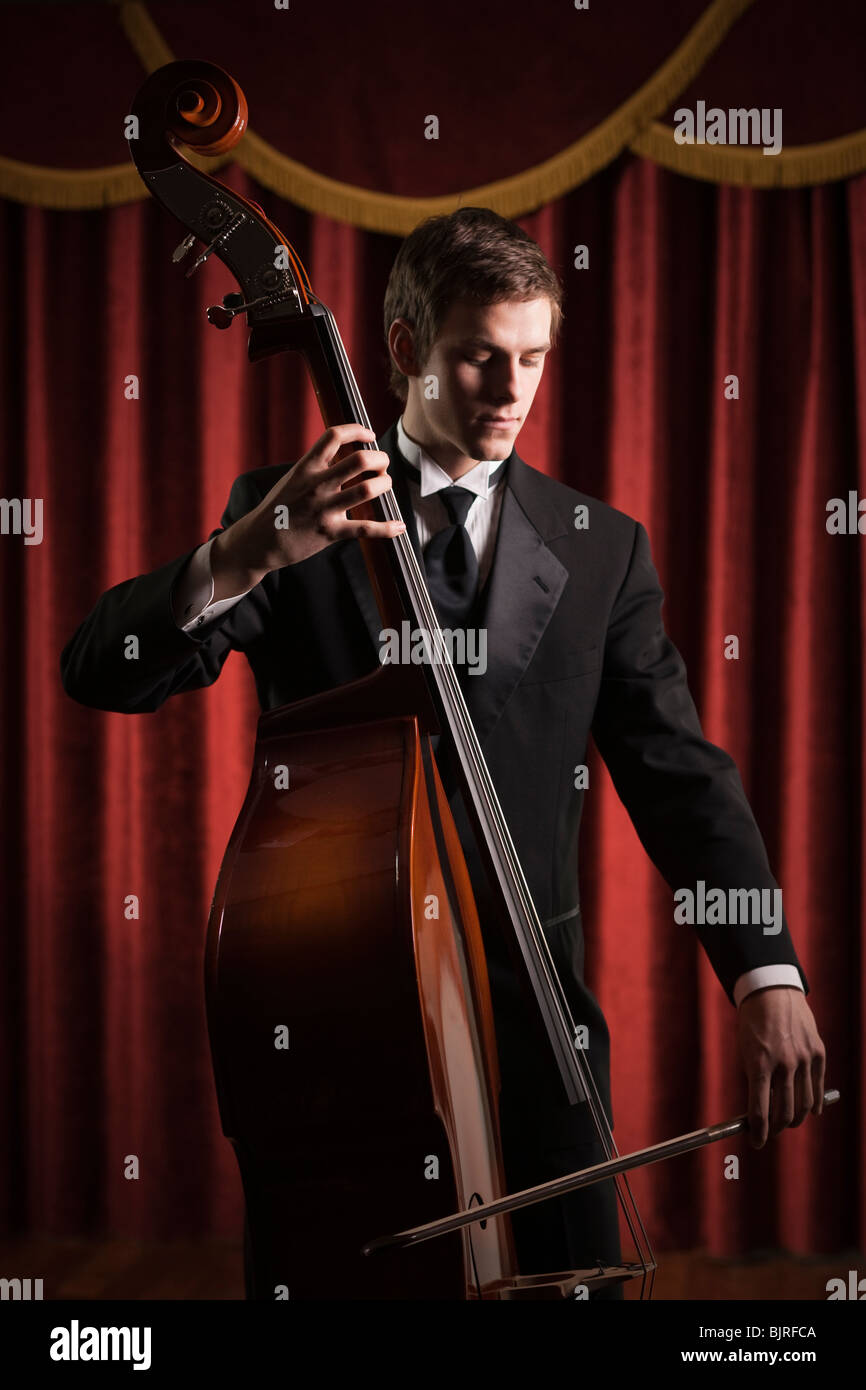 Young man playing double bass Stock Photo