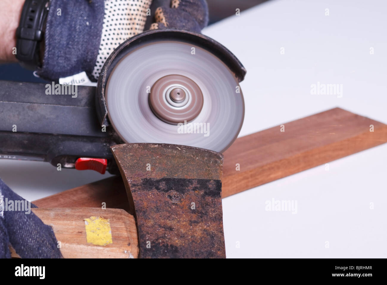 https://c8.alamy.com/comp/BJRHMR/an-angle-grinder-being-used-to-sharpen-the-blade-of-an-axe-BJRHMR.jpg