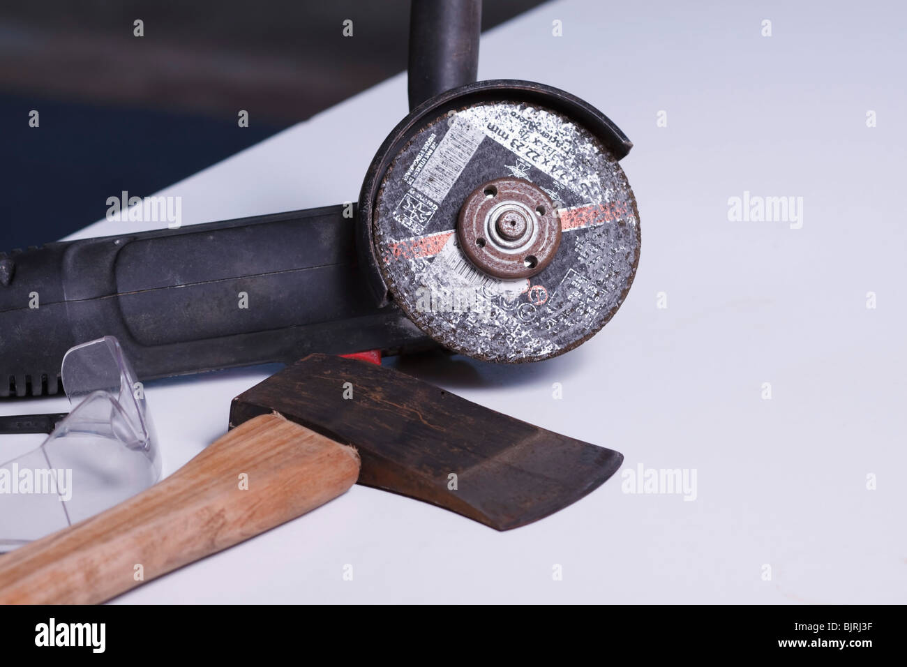 An angle grinder, axe and safety goggles Stock Photo Alamy