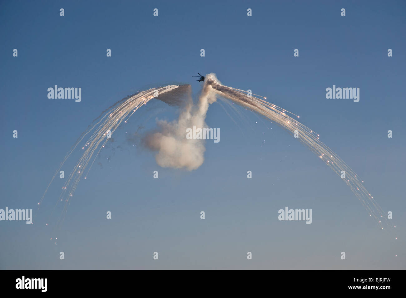 Mk8 Lynx helicopter deploying anti-missile flares Stock Photo