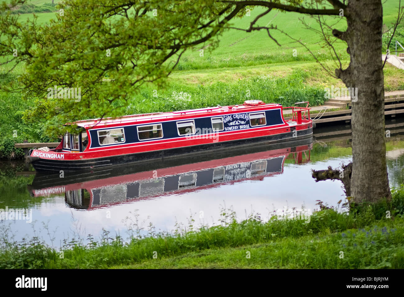 Canal boat uk - barge docked outside a lock on the Huddersfield Narrow Canal, near Huddersfield, West Yorkshire, UK Stock Photo
