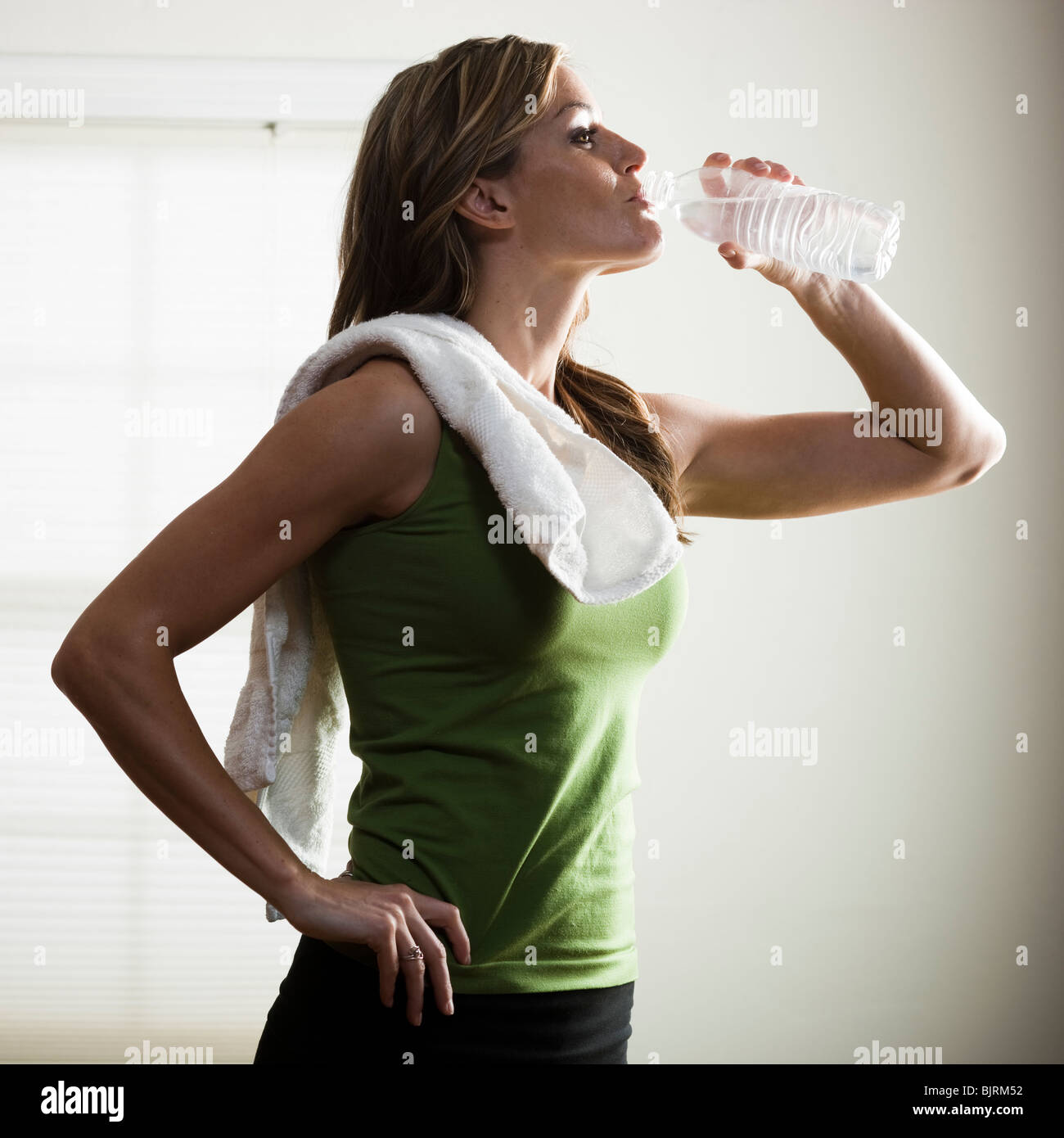 USA, Utah, Orem, young woman drinking water after exercising Stock Photo