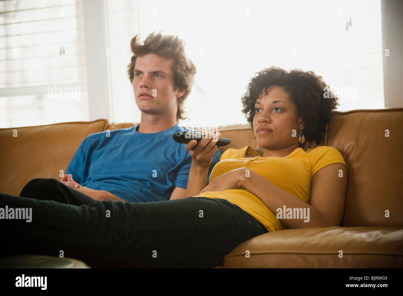 USA, Utah, Provo, couple sitting on sofa watching TV Stock Photo