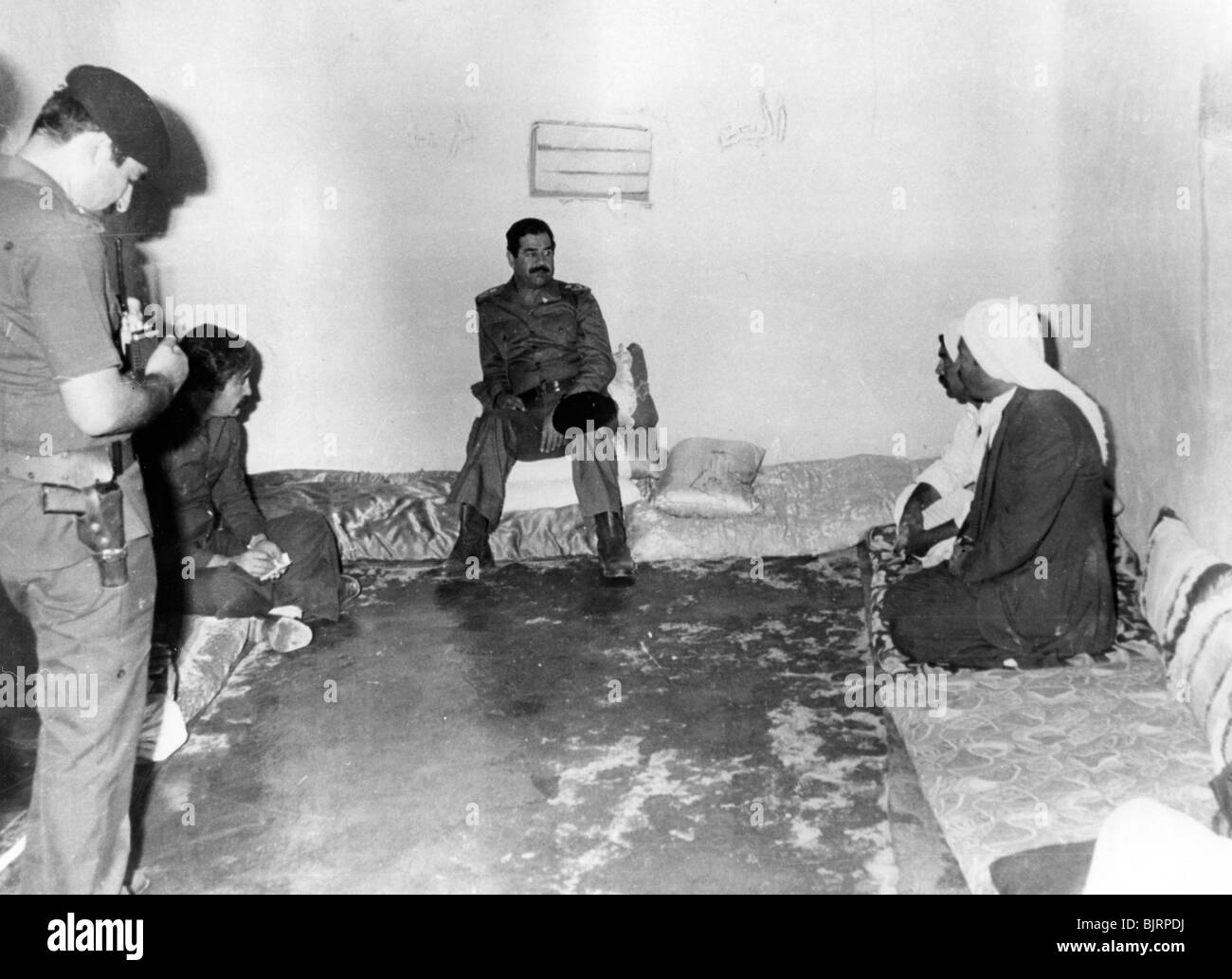 Saddam Hussein visiting a peasant house in Basra, Iraq, 1987. Artist: Unknown Stock Photo