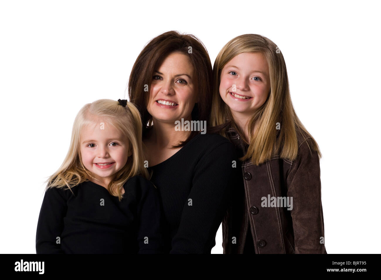 Mother posing with young daughters Stock Photo