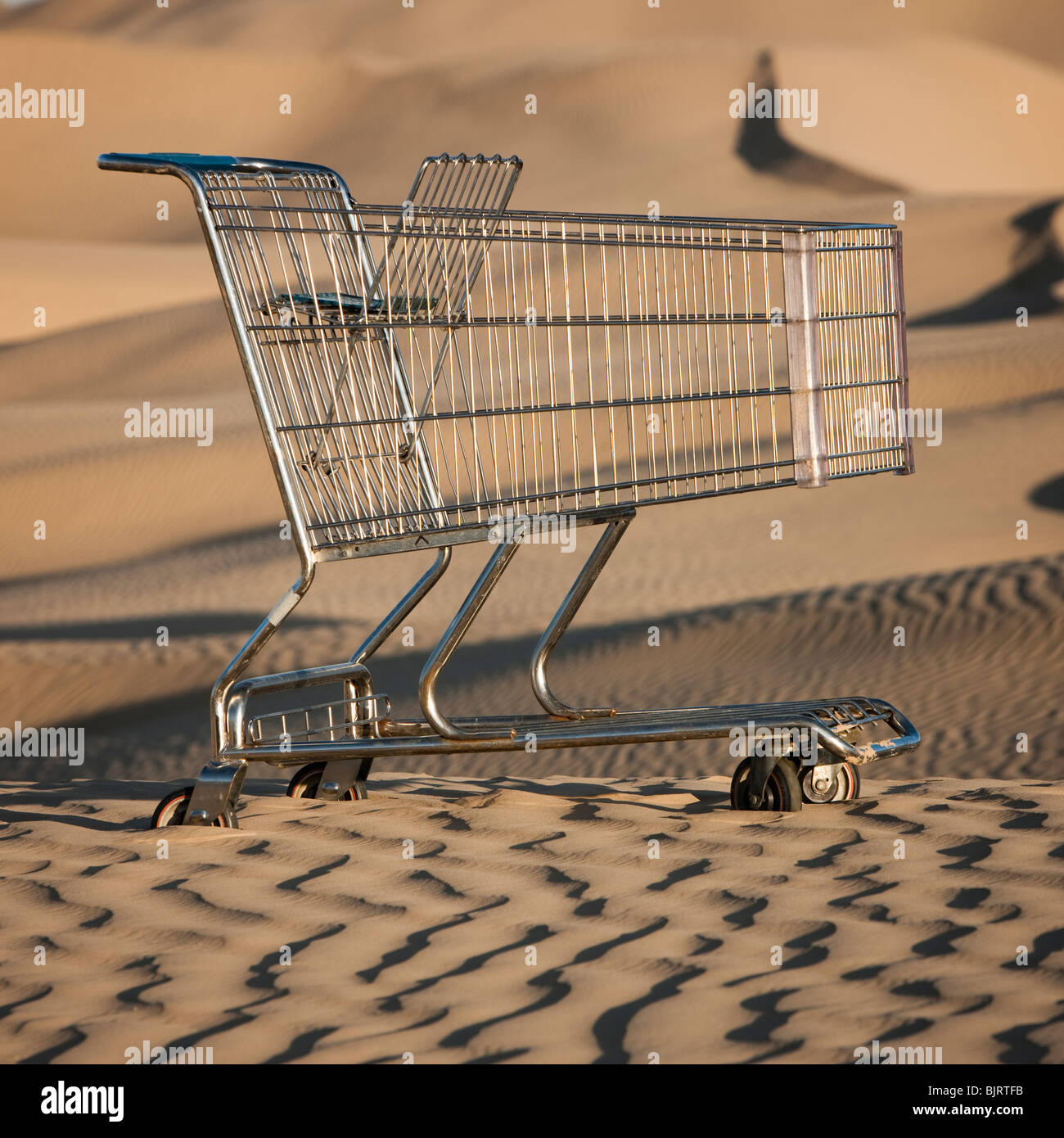 USA, Utah, Little Sahara, abandoned shopping cart on desert Stock Photo