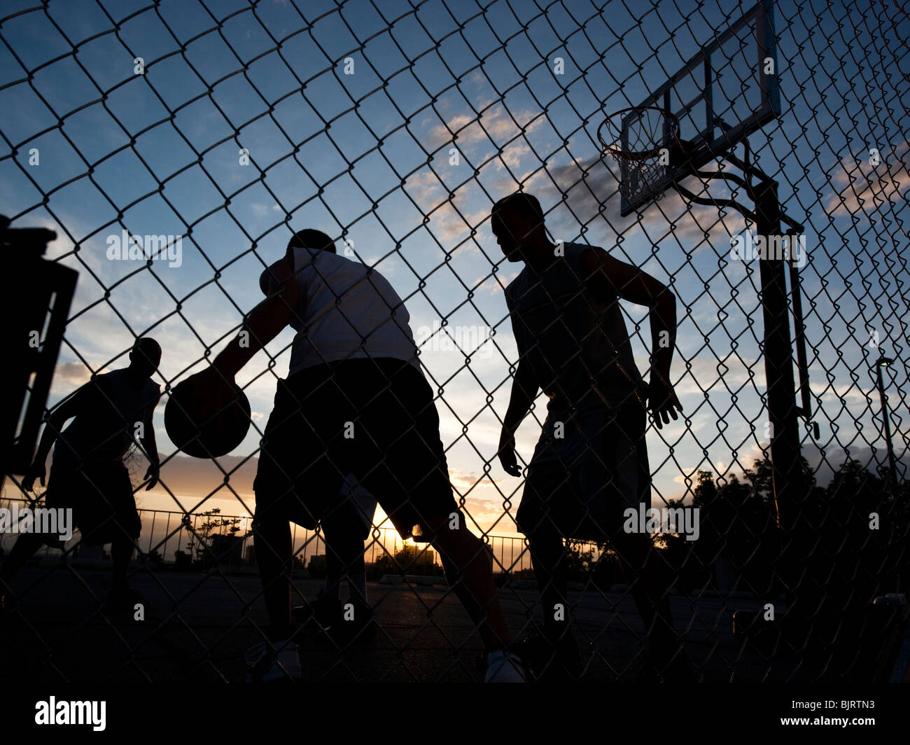USA, Utah, Salt Lake City, four young men playing street basketball, low angle view Stock Photo