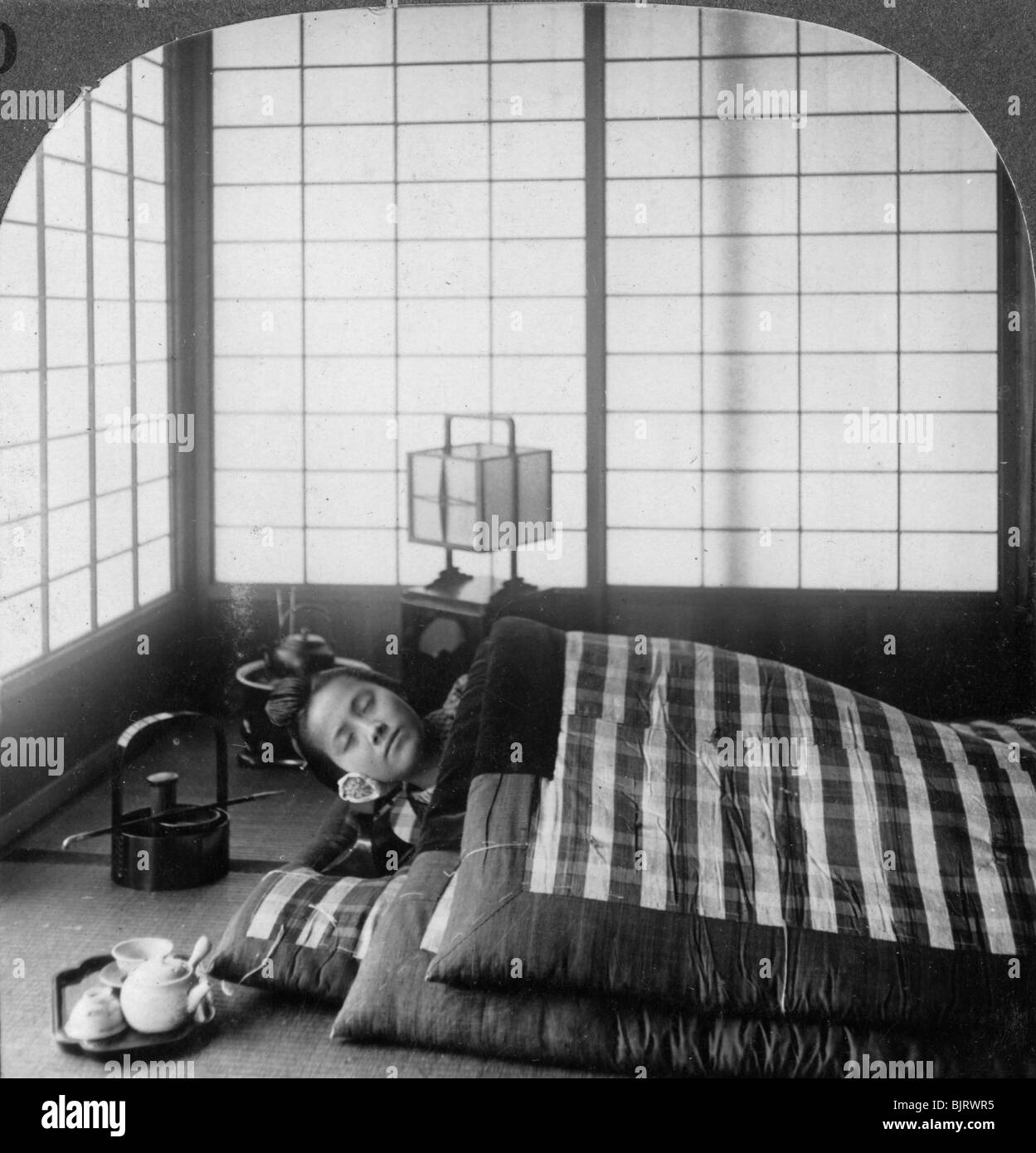 A geisha sleeping in a tea house, Hikone, Japan, 1904.Artist: Underwood & Underwood Stock Photo
