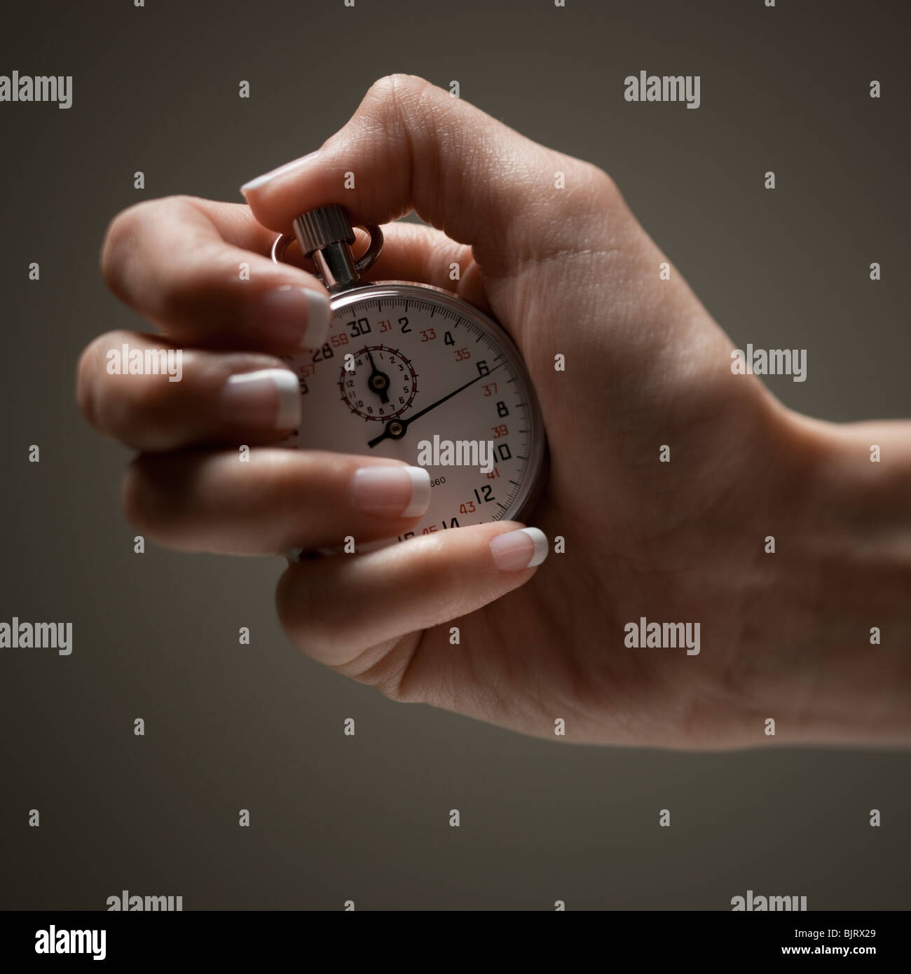Hand holding stopwatch Stock Photo