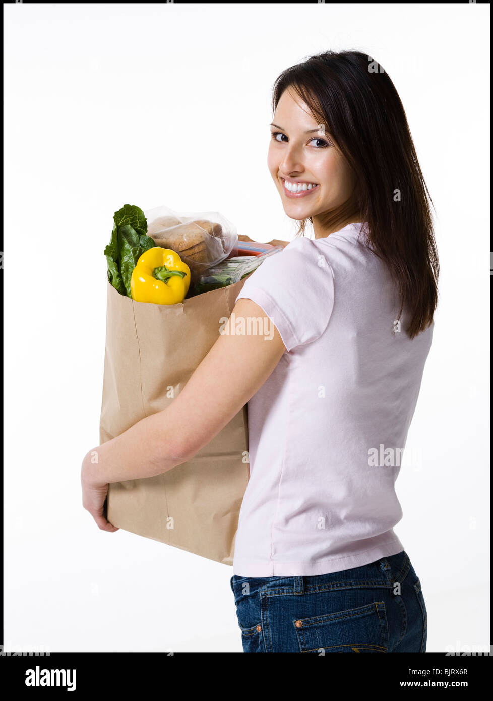 Woman holding a bag of groceries Stock Photo