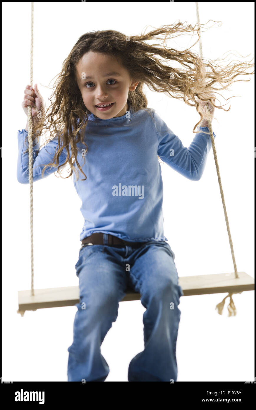 Young girl playing on a swing Stock Photo