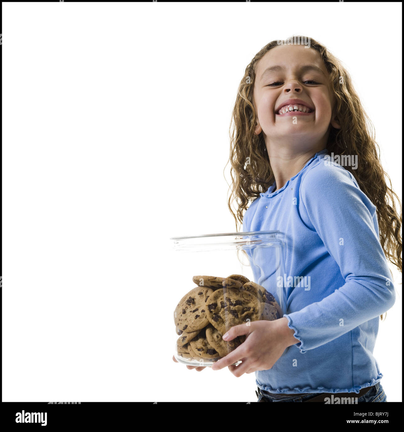 Young girl holding cookie jar Stock Photo