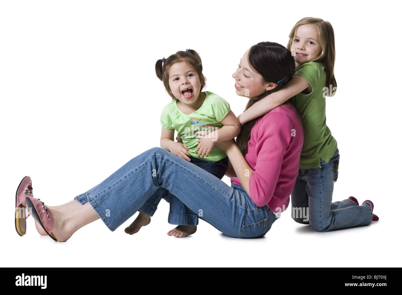 Mother posing with young daughters Stock Photo