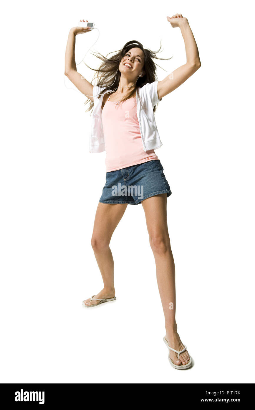 Woman listening to MP3 player and dancing Stock Photo