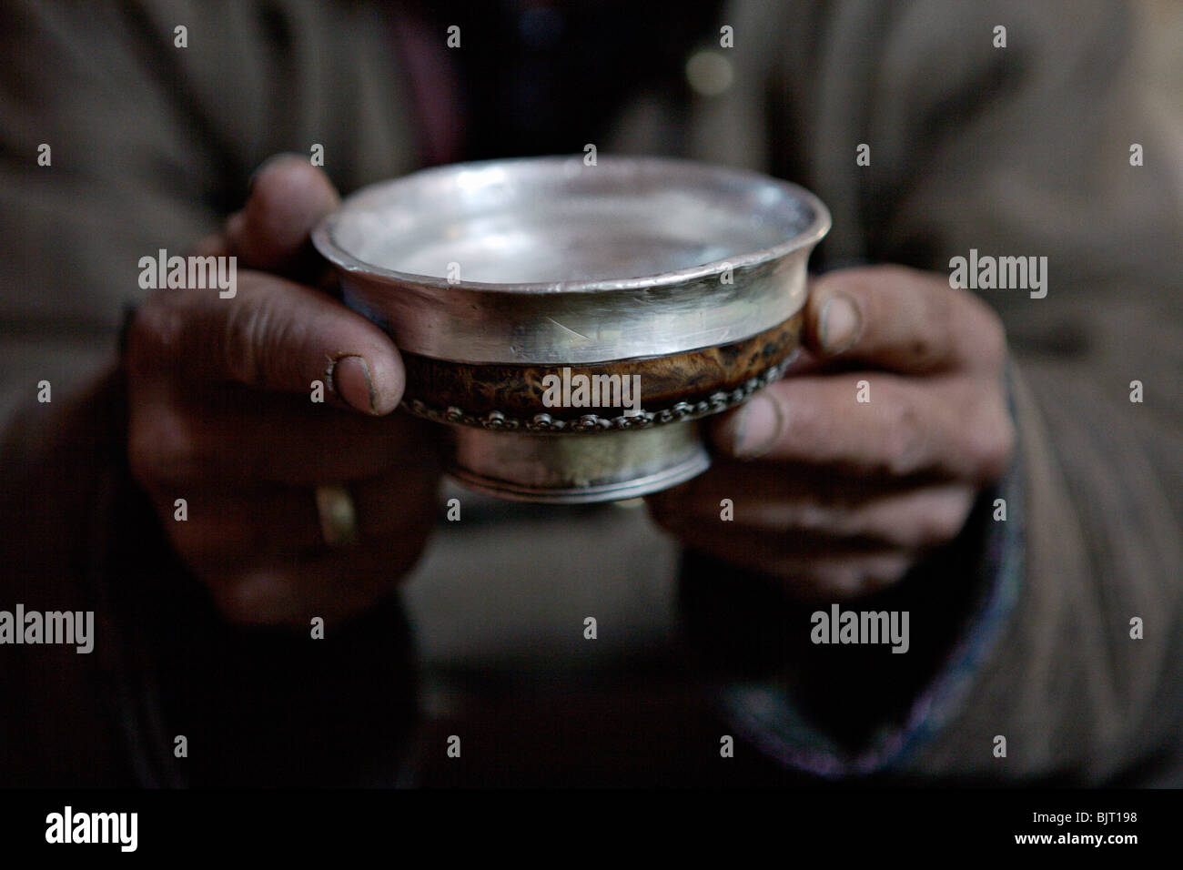 Man drinking arkhi, home-made alcohol distilled from milk, in Gobi Desert, Mongolia. Stock Photo