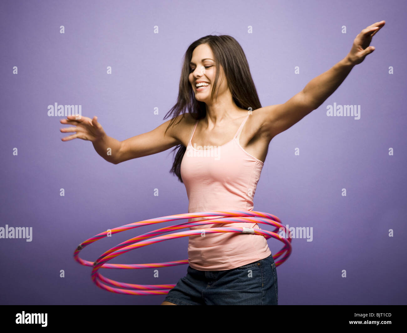 Woman dancing and playing with hula hoops Stock Photo