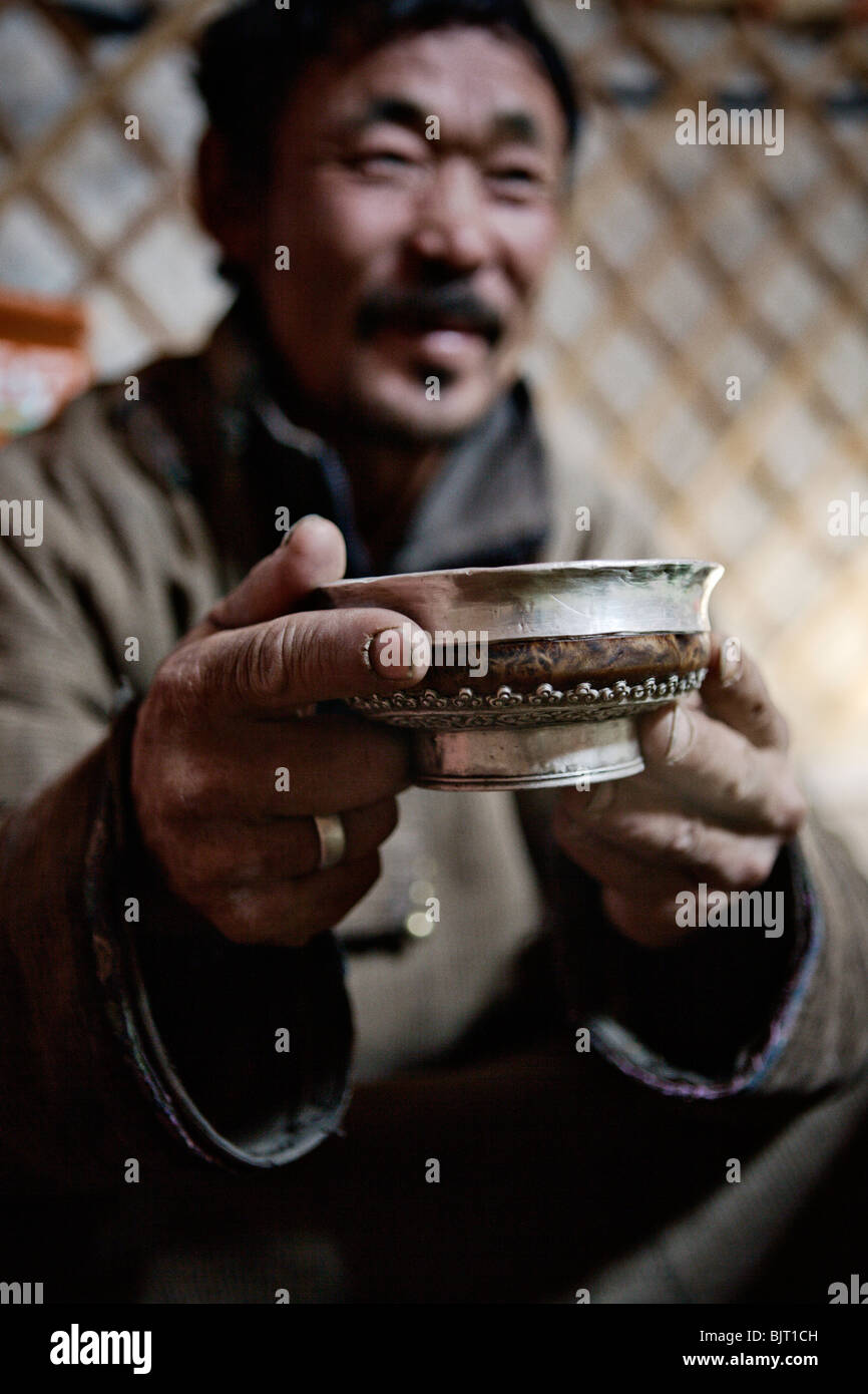Man drinking arkhi, home-made alcohol distilled from milk, in Gobi Desert, Mongolia. Stock Photo