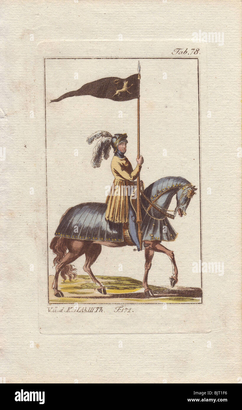 Knight in armor mounted on a fully armored horse and displaying his standard - a gold lion rampant on black pennant. Stock Photo