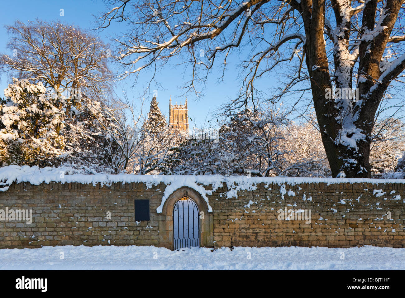 Winter snow on the Ernest Wilson Memorial Garden and St James church in the Cotswold town of Chipping Campden, Gloucestershire Stock Photo