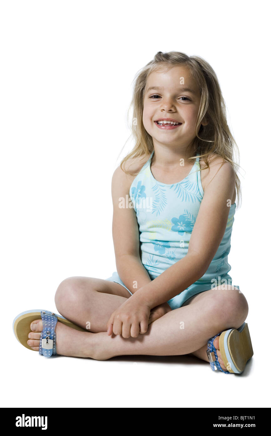 Young girl posing and sitting cross legged Stock Photo