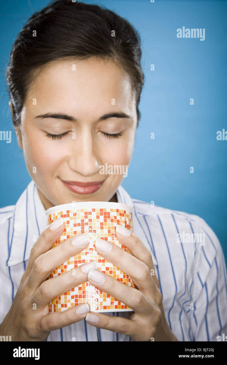 Woman enjoying a mug of coffee Stock Photo