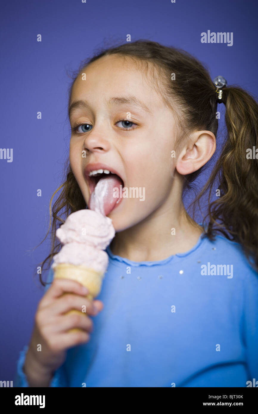 Young girl holding cone with two scoops of ice cream Stock Photo