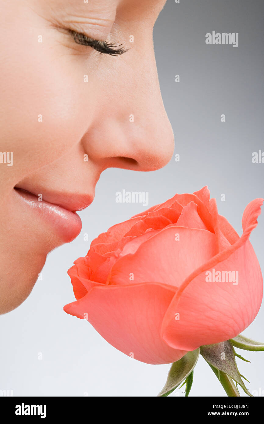 A woman smelling a rose Stock Photo Alamy