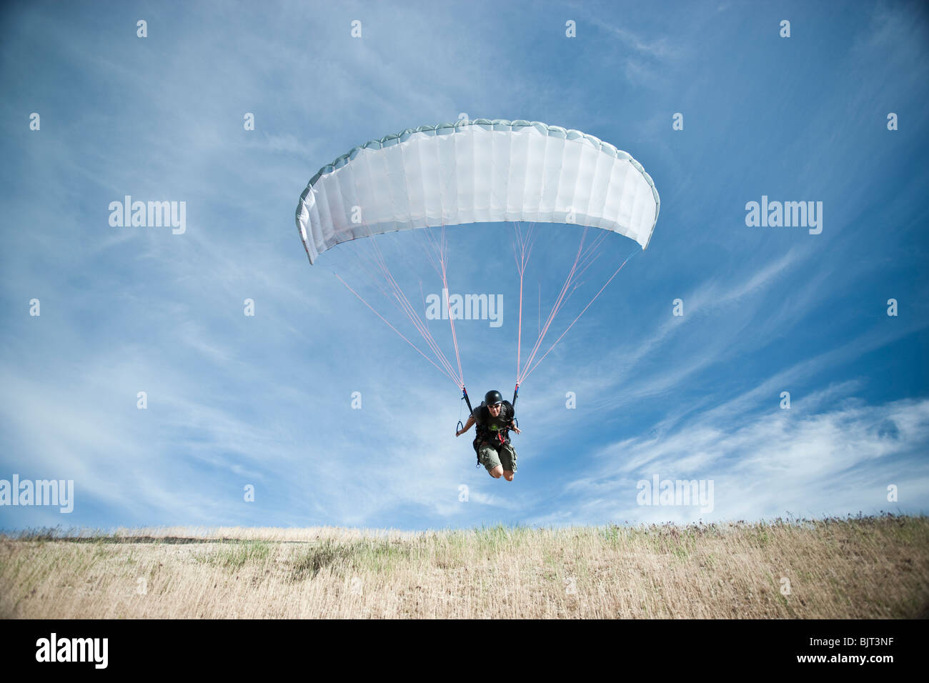 USA, Utah, Lehi, mature paraglider starting from hill Stock Photo