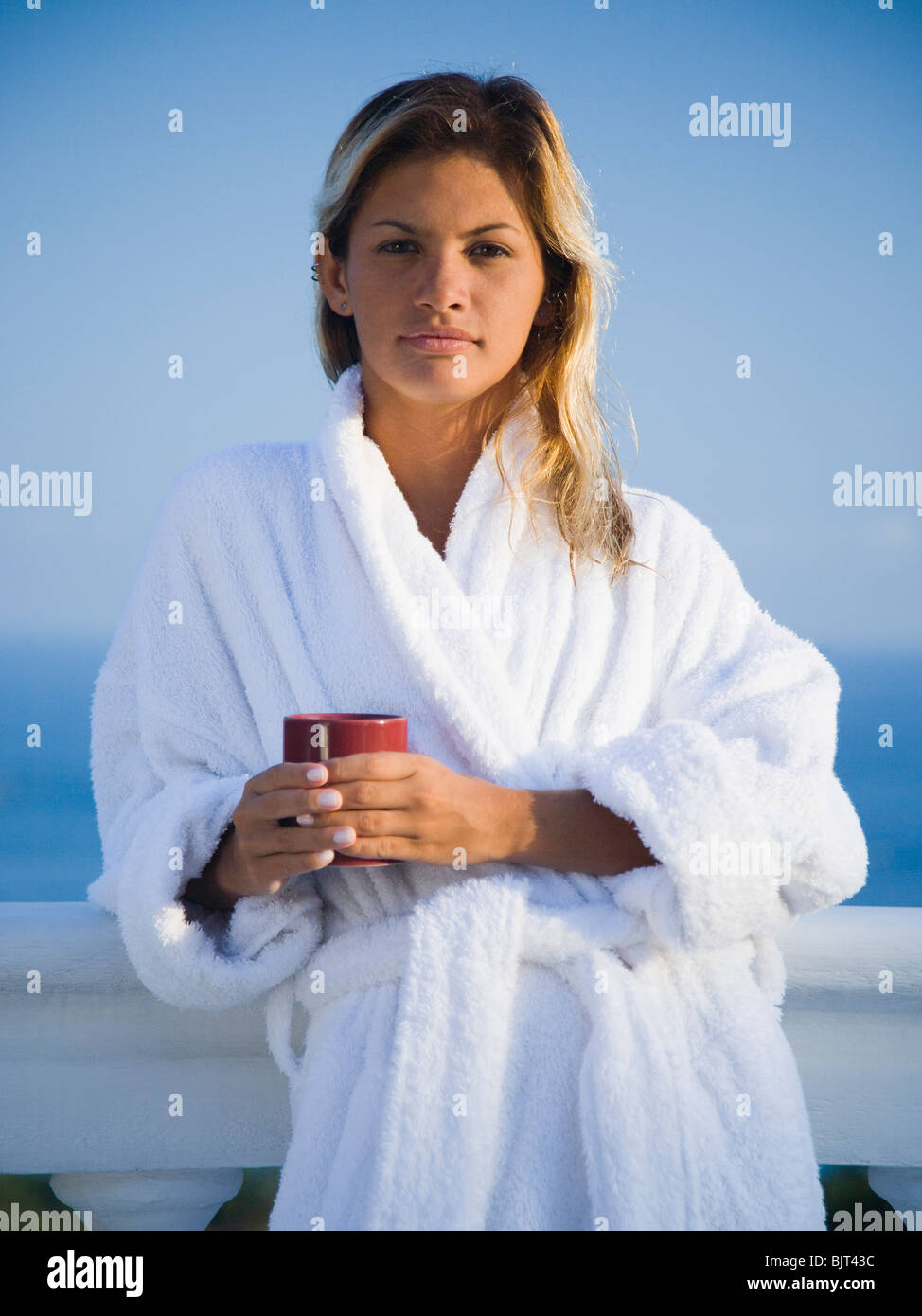 Woman in housecoat relaxing outdoors Stock Photo