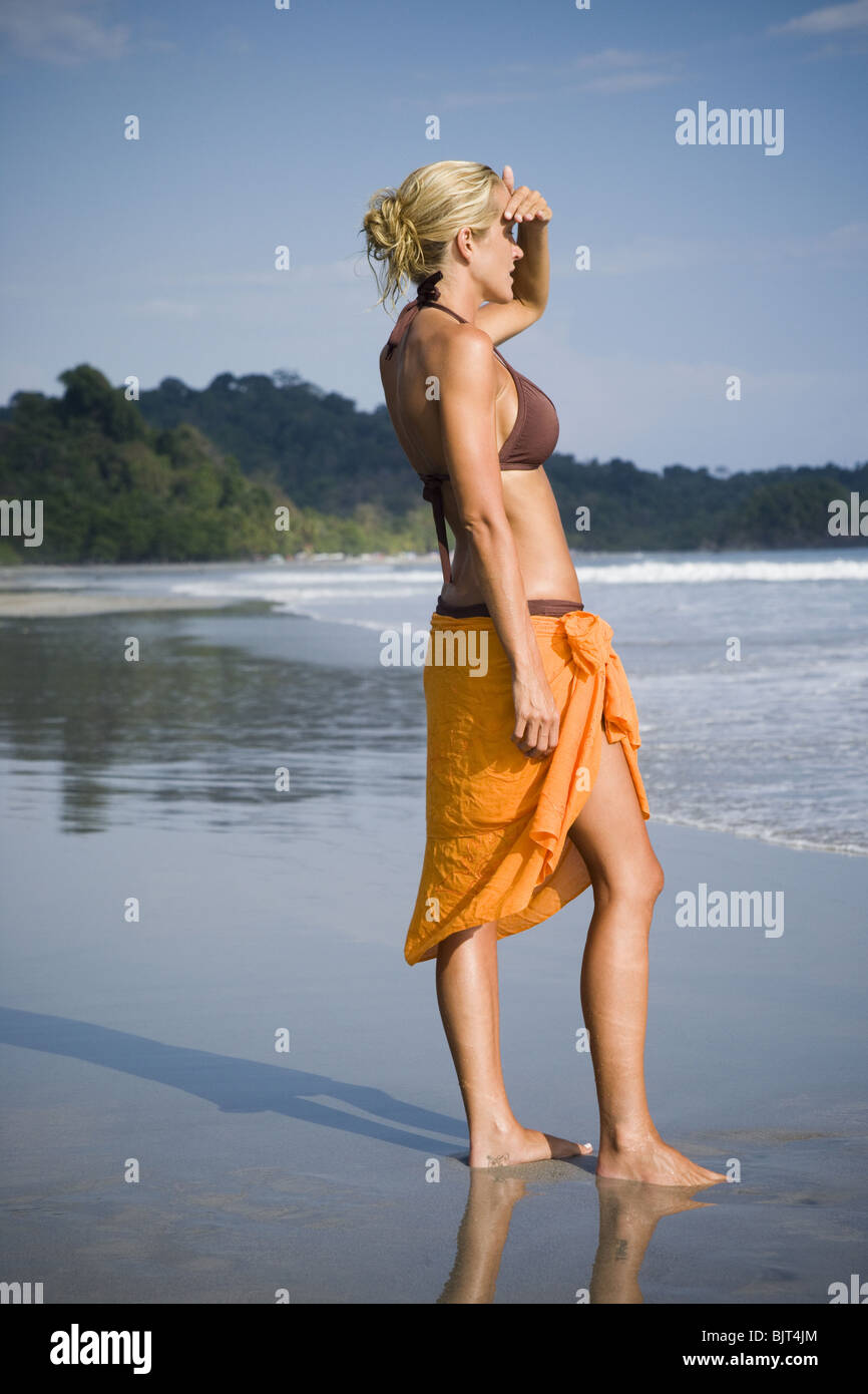 Woman walking on a beach Stock Photo