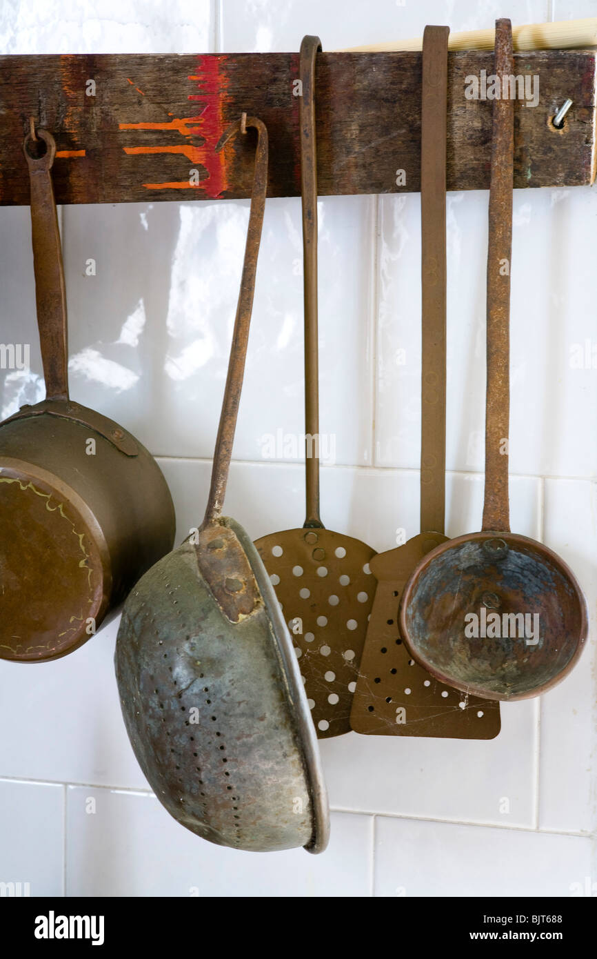Old kitchen pots and pans hanging on wall in Italy Stock Photo Alamy