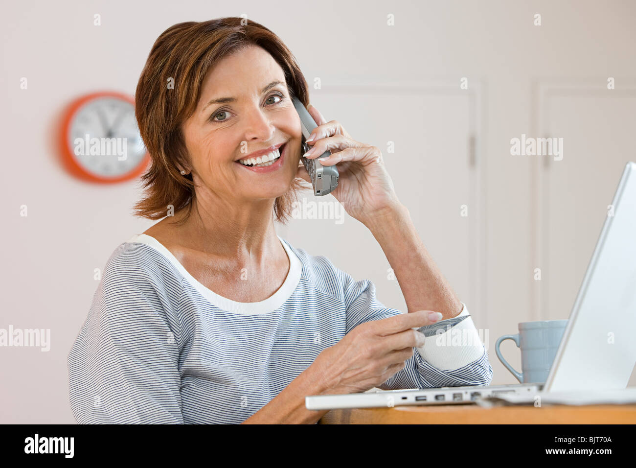 A woman telephone banking Stock Photo