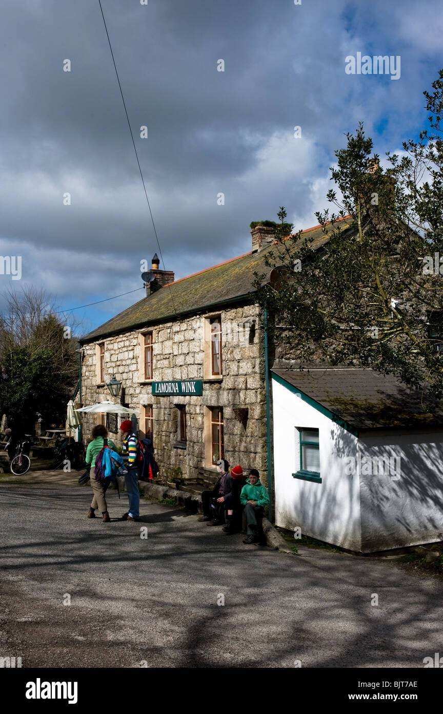 Holidaymakers waiting outside the Lamorna Wink public house in Cornwall. Stock Photo