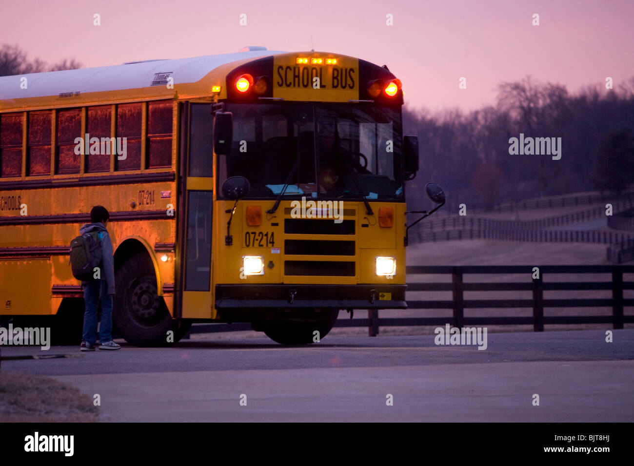School bus in the early morning making a stop to pick up students, Franklin, Tennessee Stock Photo