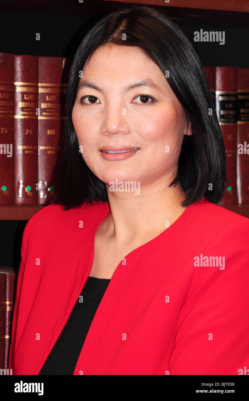 Model released portrait of female lawyer with law books in background Stock Photo