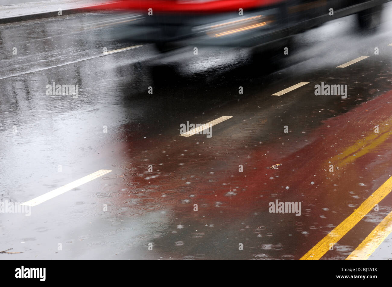 Vehicle on wet Road Surface Stock Photo