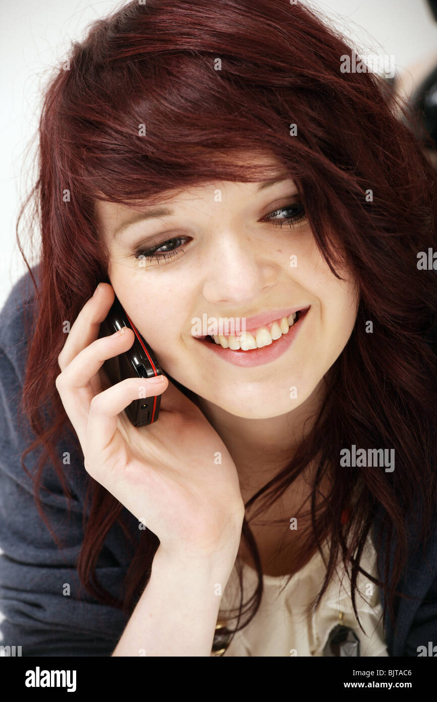 A happy teenage girl hold her mobile phone in her hand Stock Photo
