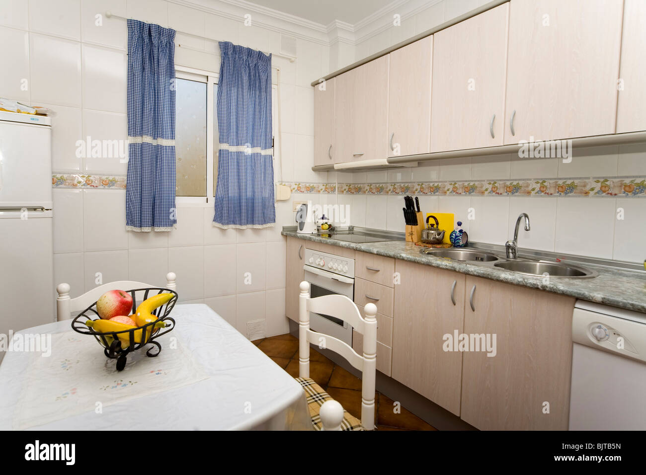 Small modern domestic kitchen with electrical appliances Stock Photo