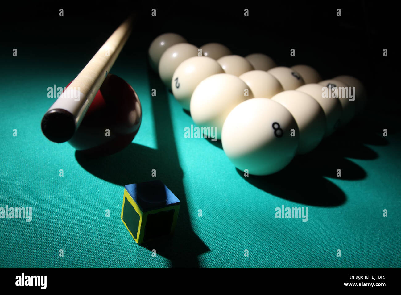Billiard “Russian Pyramid” equipment on a table in light beam Stock