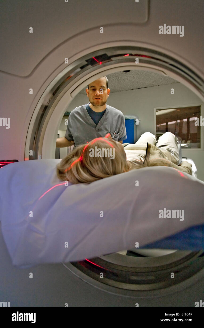A medical technician prepares a patient for a CT examination at a California radiology clinic
