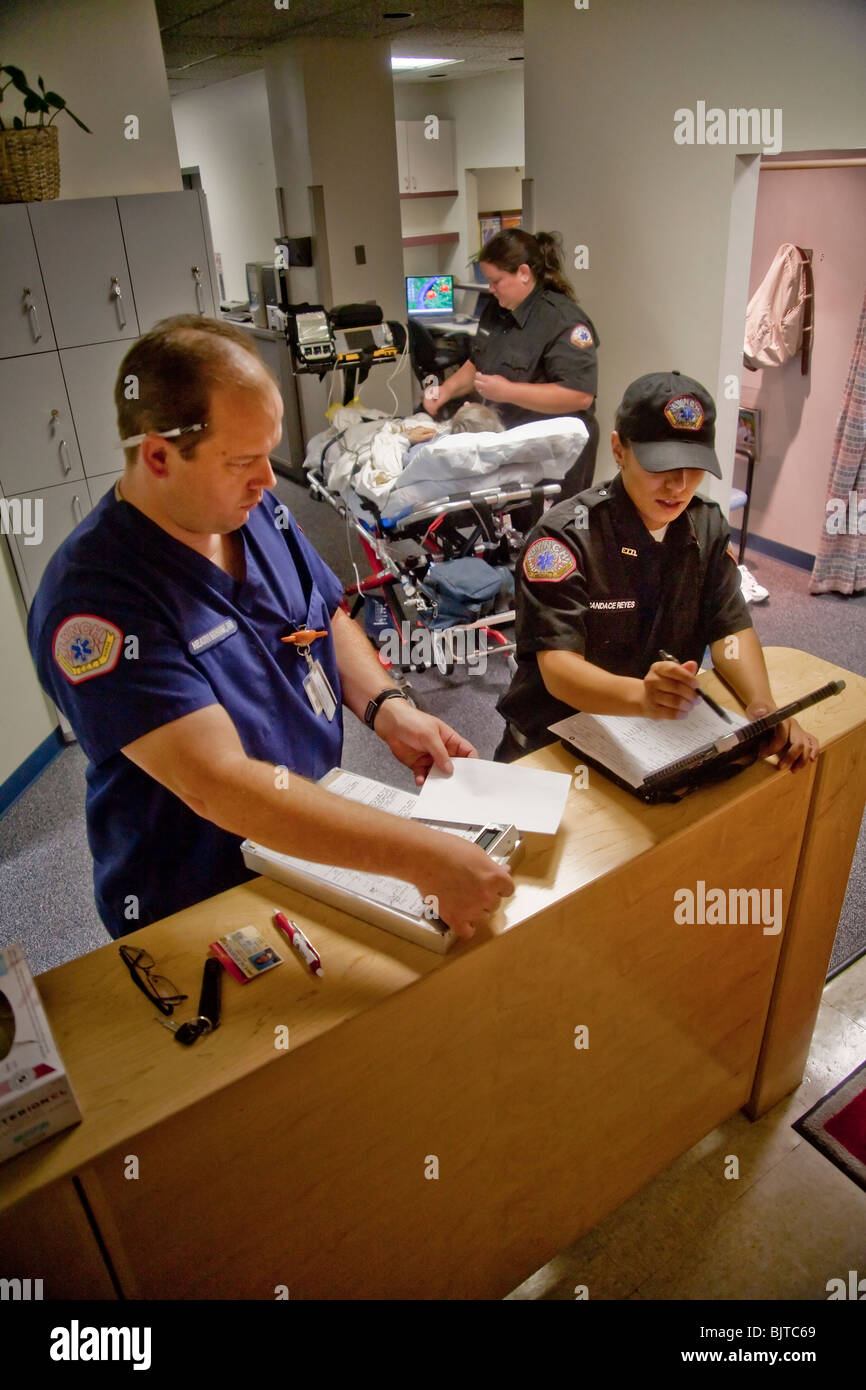 Emergency medical technicians, registered nurse (left), fill out