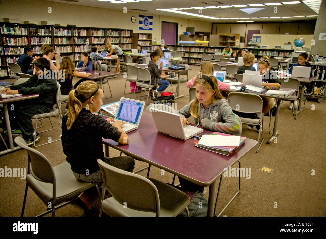 Sitting at laptop computers, California middle school students write