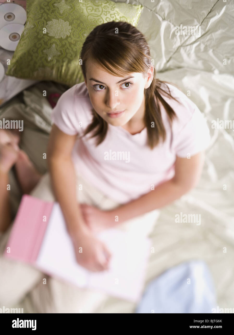 Teenage girl contemplating with notebook and pen Stock Photo