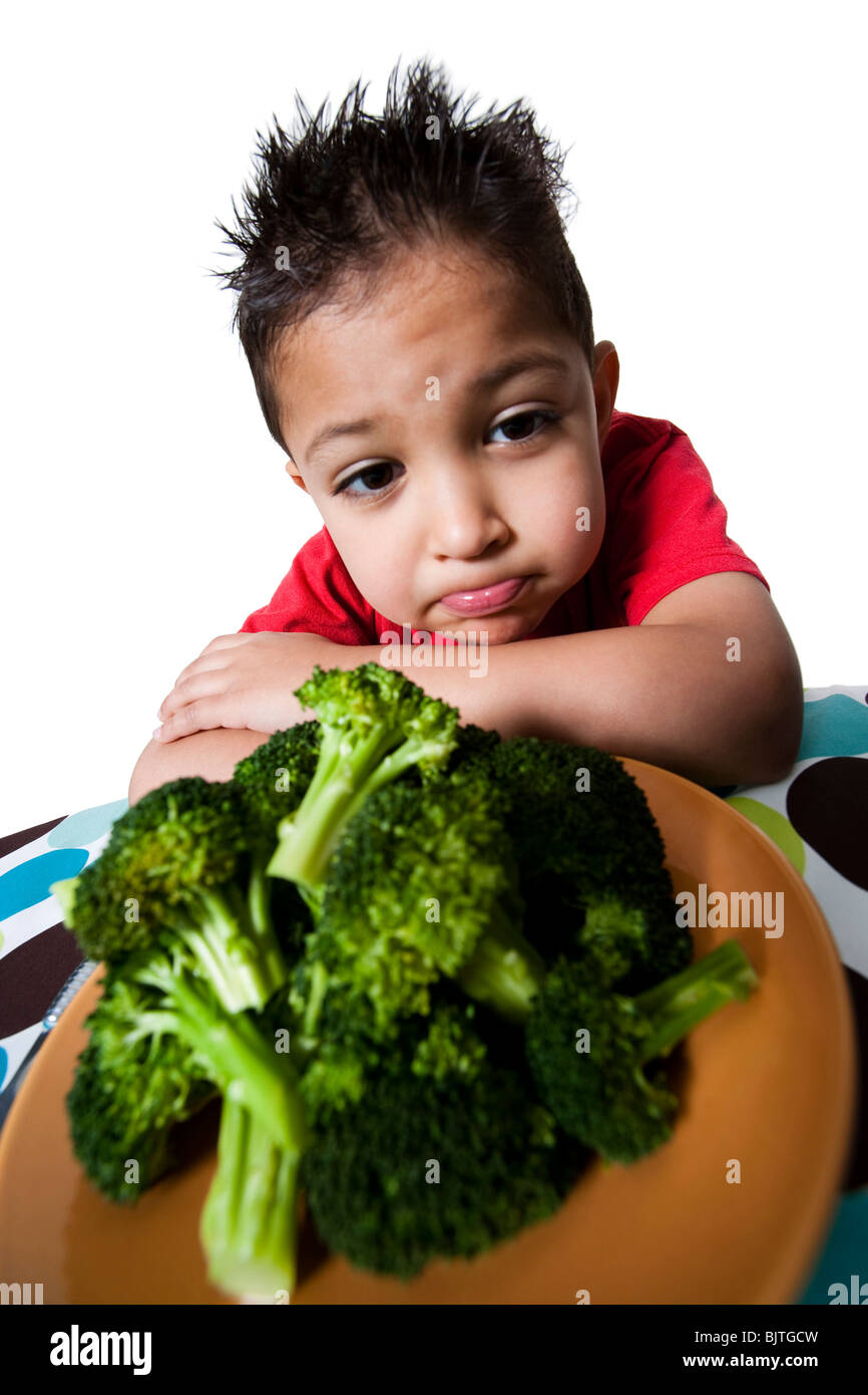Boy with plate of broccoli frowning Stock Photo Alamy