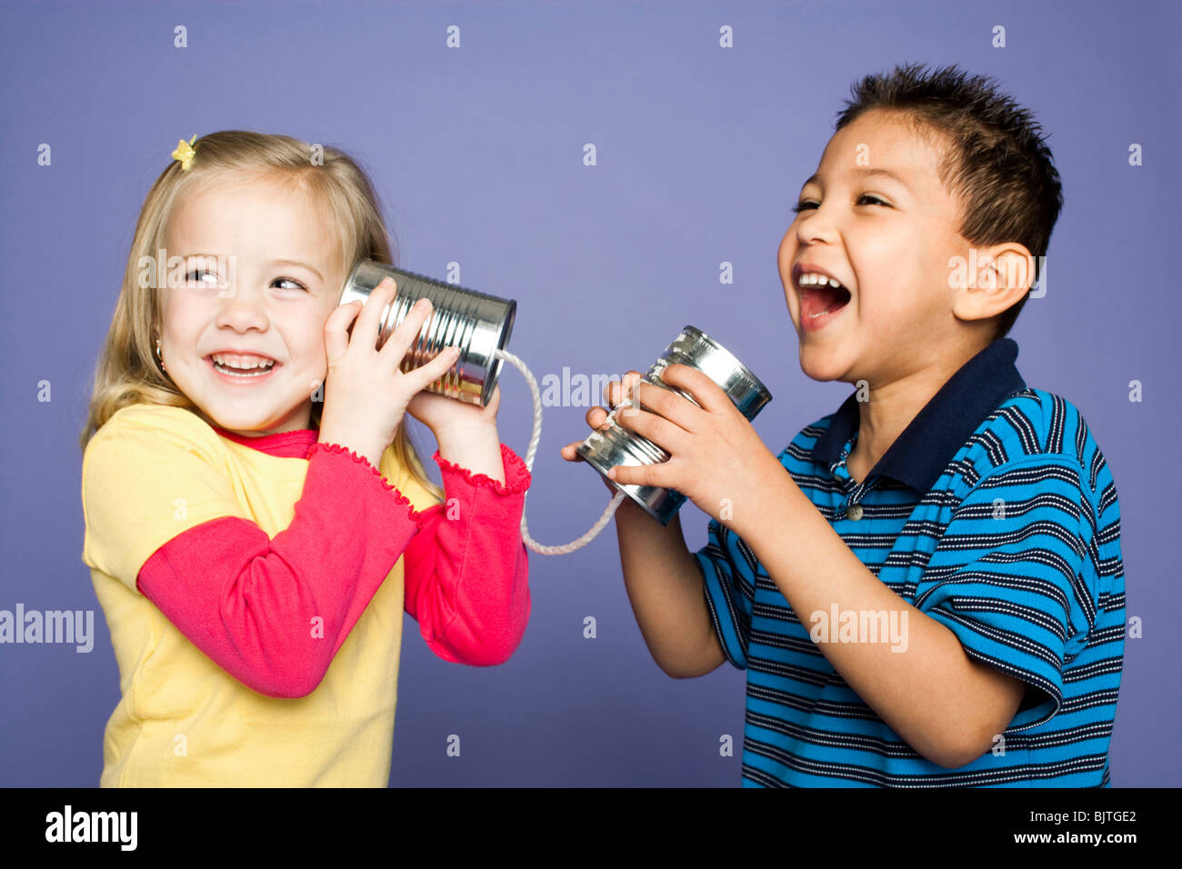 Little boy and girl with tin cans and string Stock Photo Alamy
